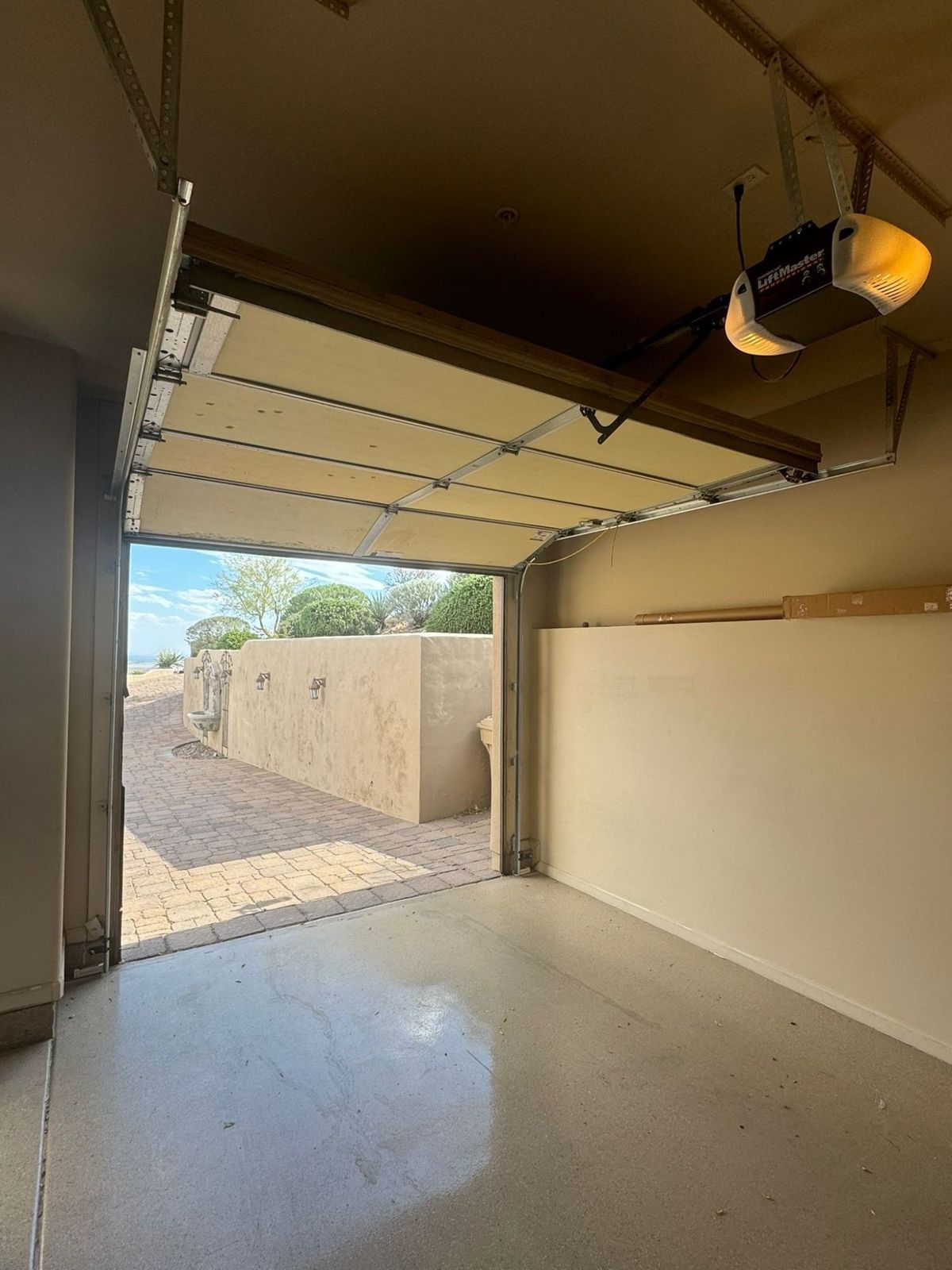 LiftMaster opener above an open garage door with a desert view