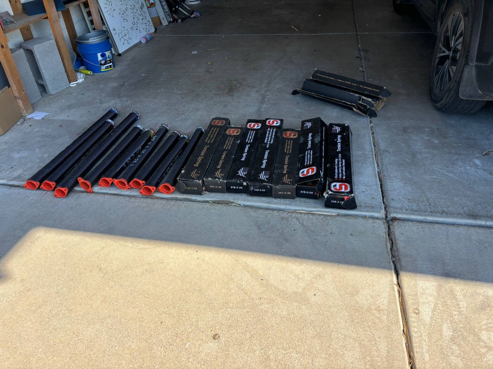 New torsion springs lined up for garage door spring replacements.