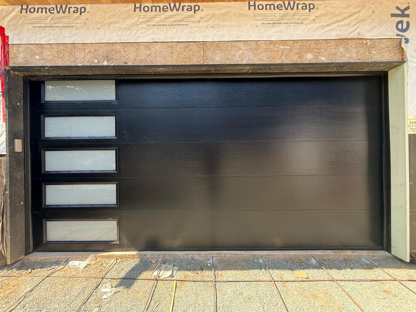 Finished white garage door replacement with accent windows on a Phoenix home.
