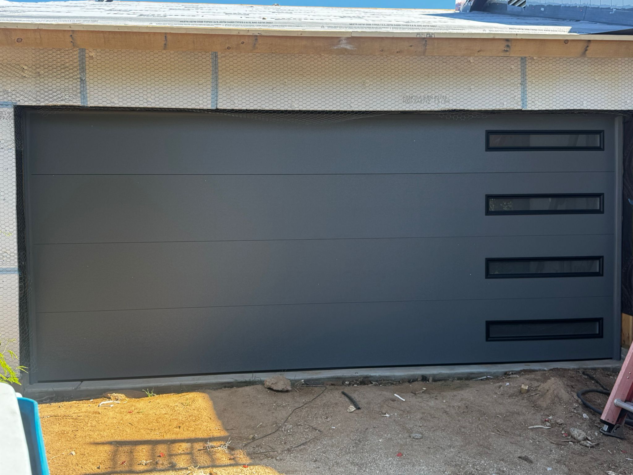 Two new white garage doors replaced on a two-car Phoenix home.