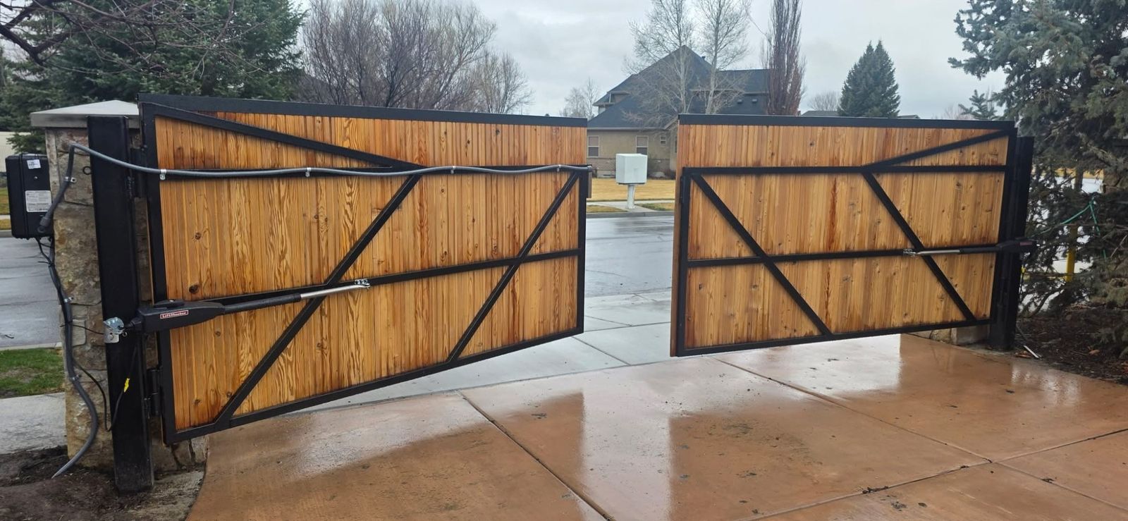 Wood double swing gate with automatic gate operator arms